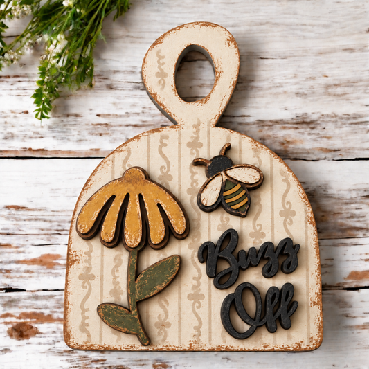 AI painted inspiration for Buzz Off bread board, black words and bee head with ornamental stencil