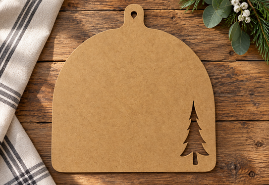 Unfinished dome breadboard with tree cutout on a rustic tabletop